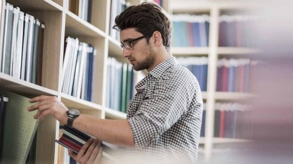 Young man taking books in one of the UK's University Technical Colleges.