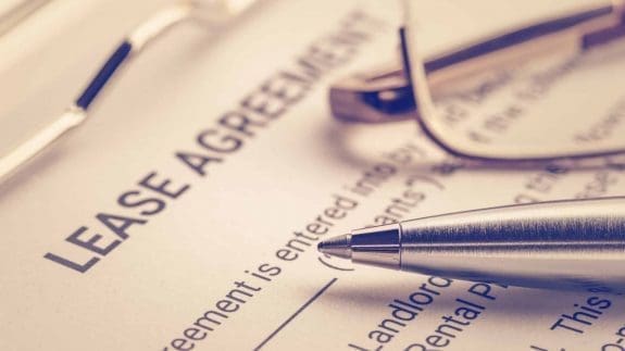 Business legal document concept : Pen and glasses on a lease agreement form. Lease agreement is a contract between a lessor and a lessee that allow lessee rights to use of a property owned by lessor