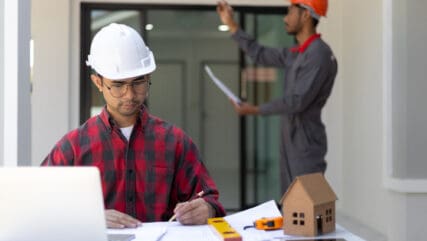 Contractors in hard hats working on construction of a commercial office