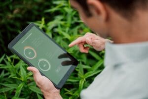 Farmer using a tablet to check on his land.