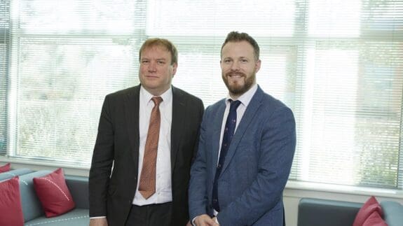 Andrew Park and Rich Grimster standing side by side in the Price Bailey office.