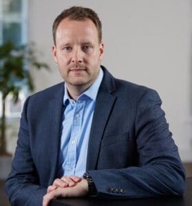 Lewis Ratcliffe sitting in office