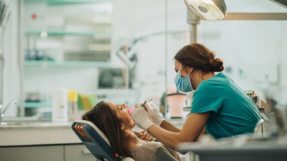 Dentist in a clinic checking a patients teeth