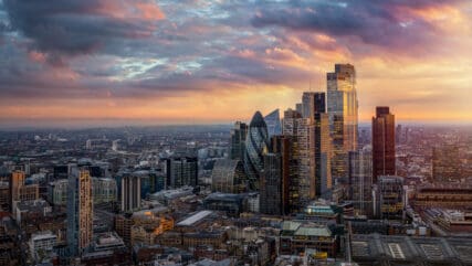 Beautiful sunset view of the financial skyscrapers at the City of London, England, until back to Tower Bridge